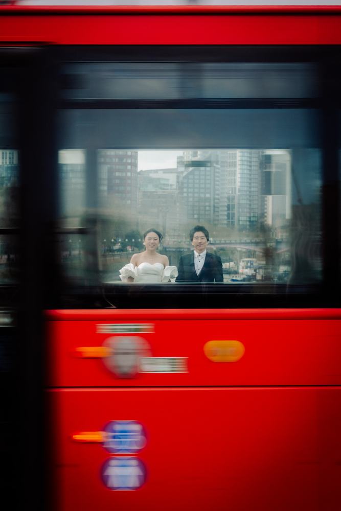 Couple seen through the window of a red London bus