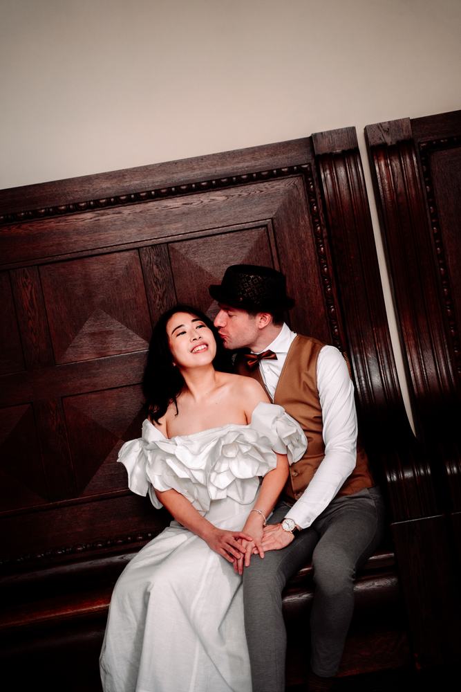 Bride and groom sitting on a wooden staircase