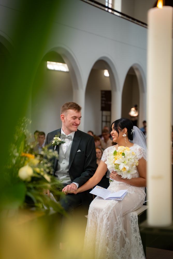 Couple at the altar framed by flowers