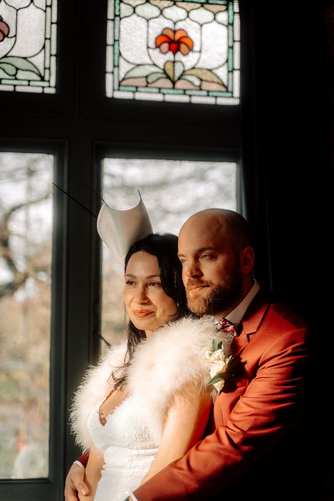 Couple in window light, cheek to cheek