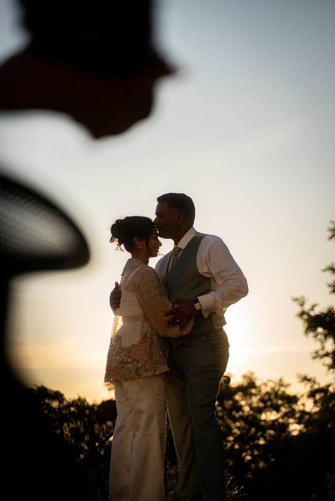 Couple silhouetted at sunset
