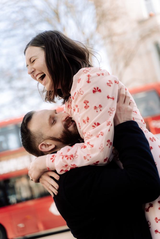 Man lifting his partner, both laughing