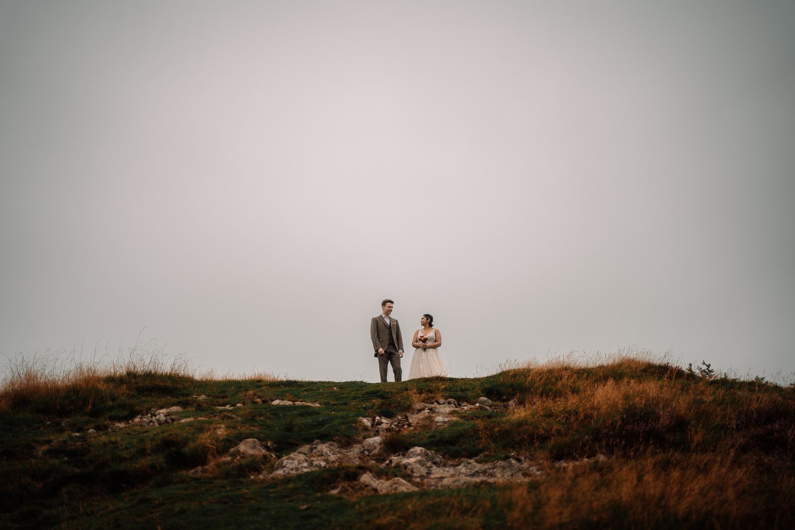 Tiny couple on a Highland hilltop