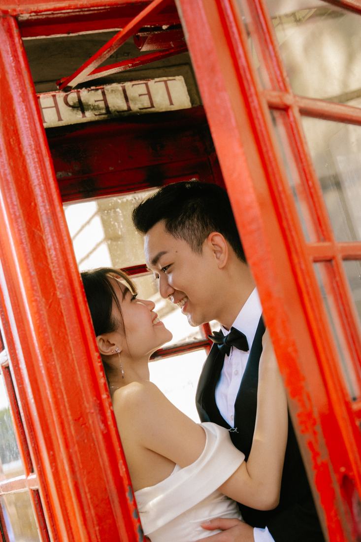 Bride and groom in a red phone box
