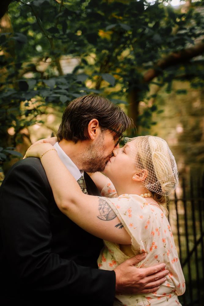 Couple kissing under trees