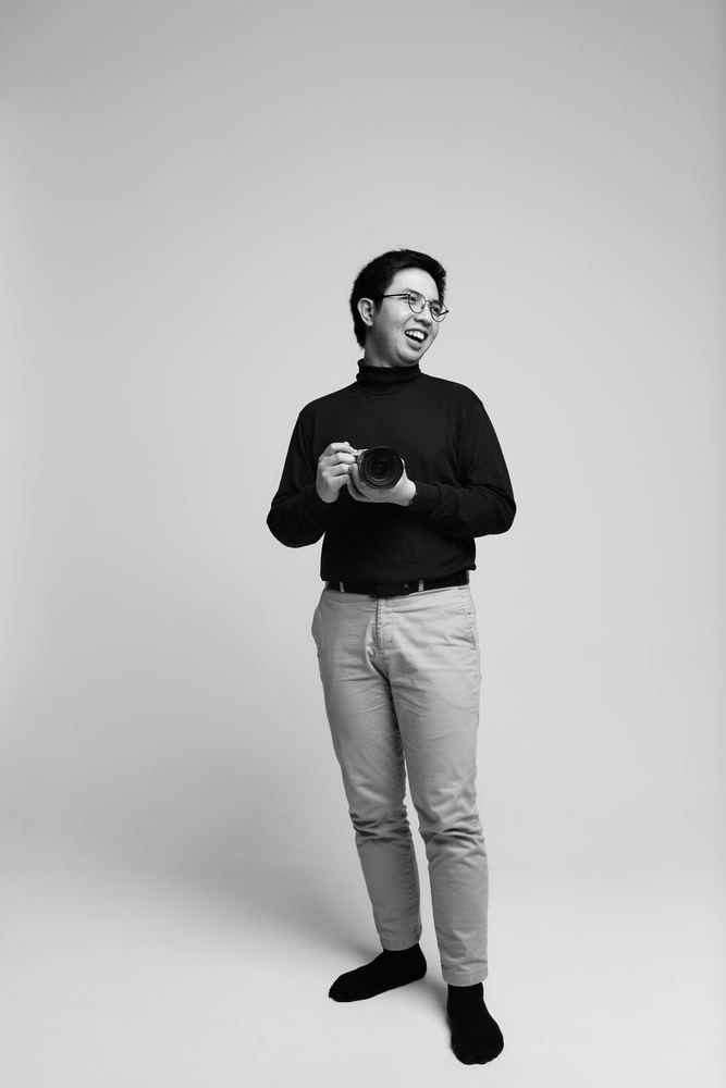 Stefan laughing, holding a camera